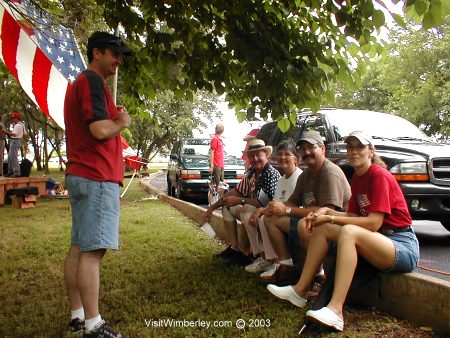Curb sitting and visiting at Wimberley Ozona Bank
