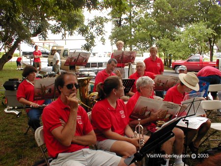 Curb sitting and visiting at Wimberley Ozona Bank